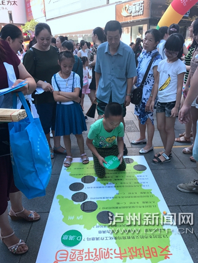 市民在宣傳點(diǎn)參加創(chuàng)文趣味游戲。 記者 朱虹 攝